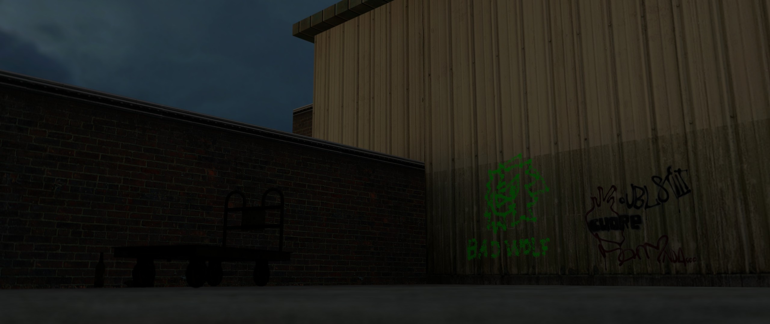 Green graffiti of a wolf head and the caption 'BAD WOLF' is painted where the side of a warehouse meets a brick wall.